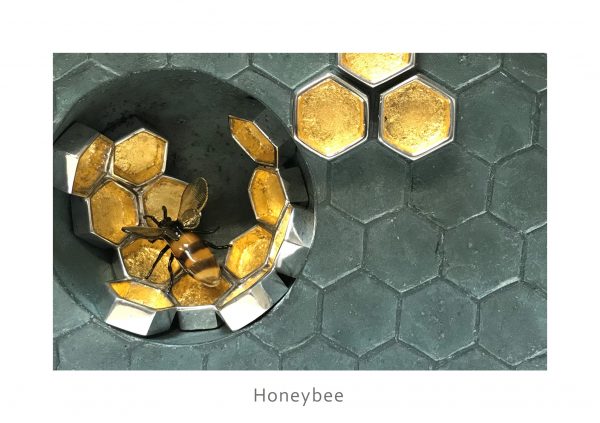 glass bee in concrete honeycombe with gold leaf honey