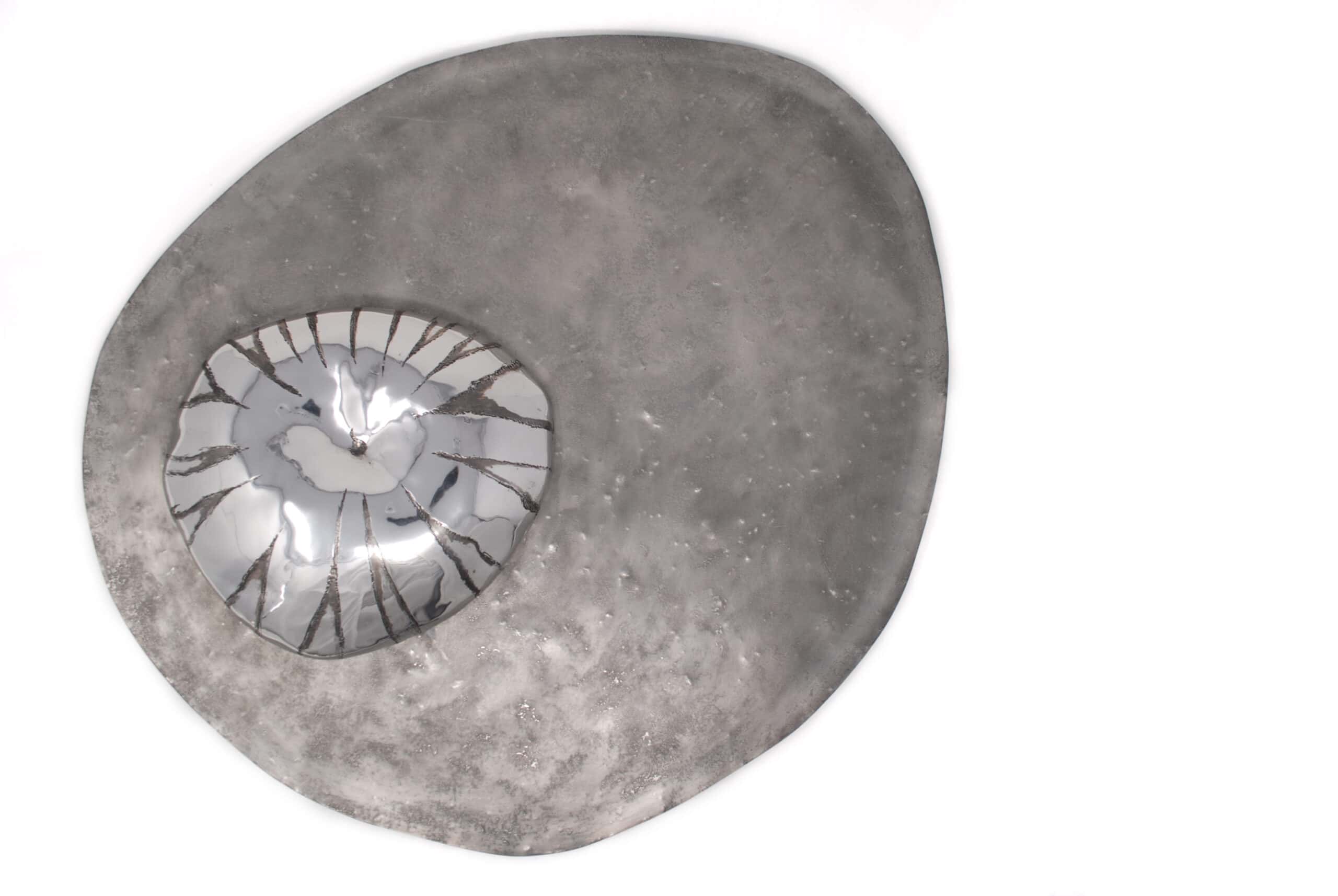 Wall piece irregualer shape background of mat pewter with stippled texture with bulbous petwer compass jellfish on top