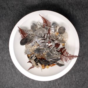 Hidden honesty sculpture displayed in wooden bowl