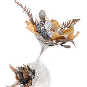 Silent Flourish contemporary hand-raised pewter sculpture by Fleur Grenier featuring preserved woodland botanicals and cast pewter leaves in an elegant flowing vessel.