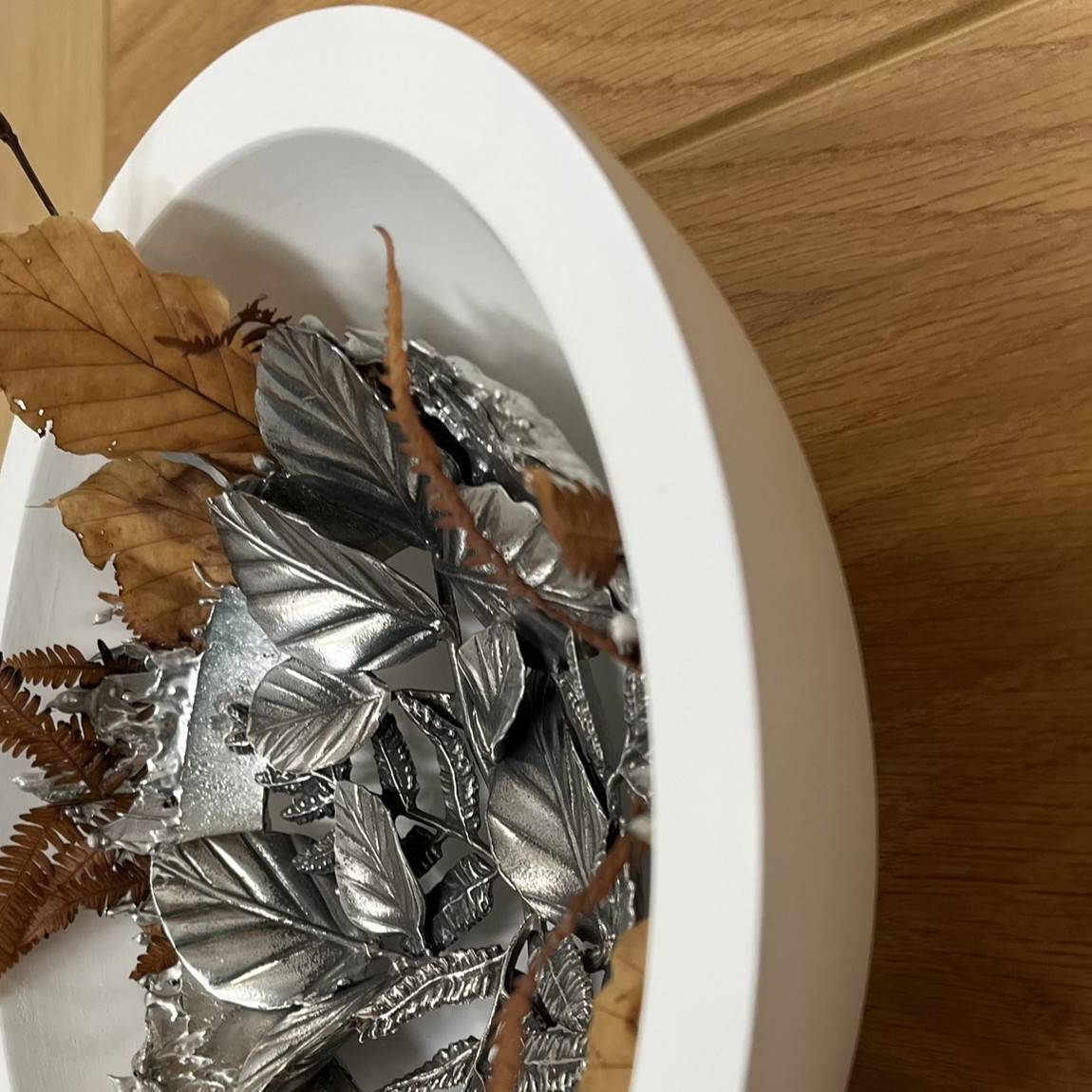 side view of hidden leaves and ferns in a bowl